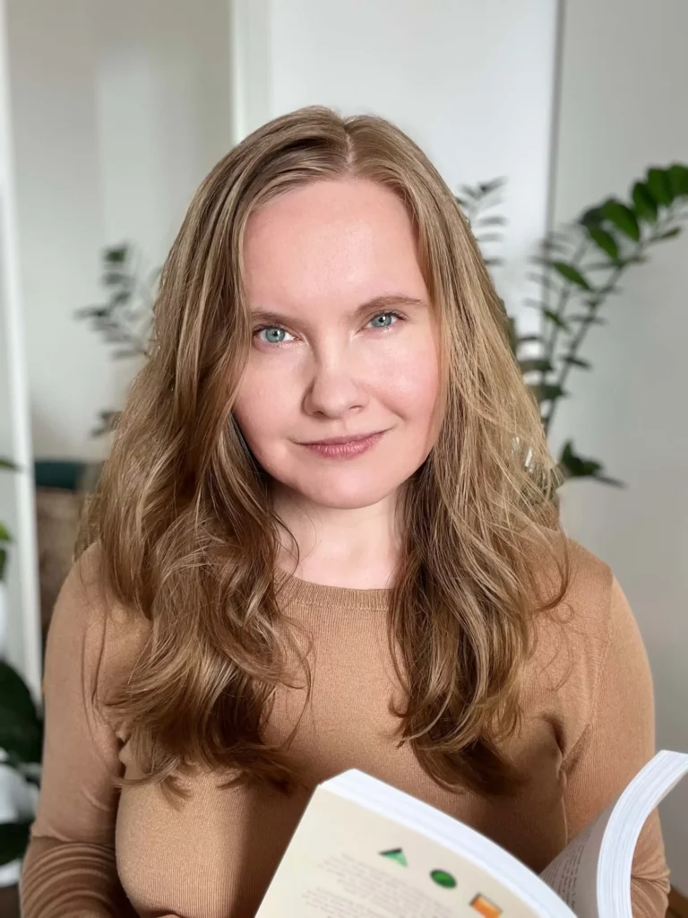 Portrait of the Art Wanderer founder with a book