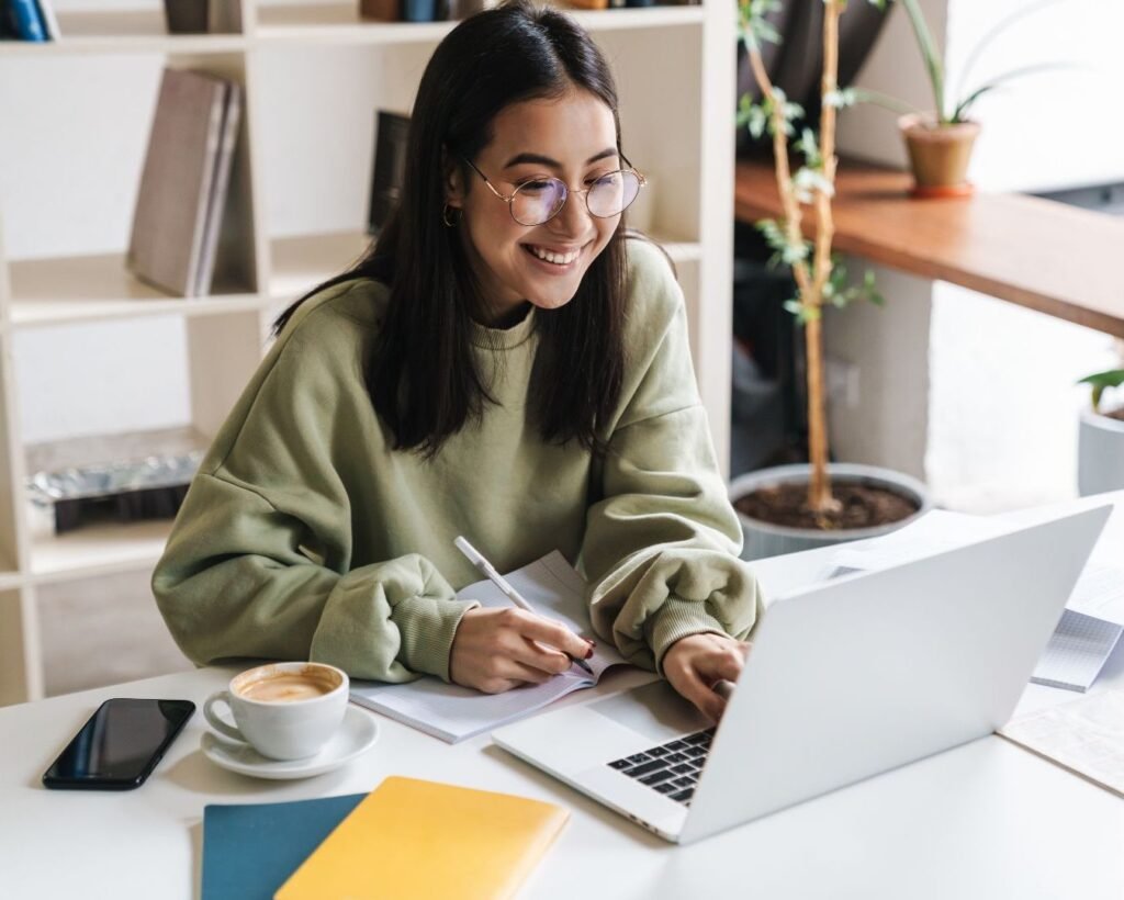 Smiling woman learning on laptop — exploration stage of the Art Wanderer method